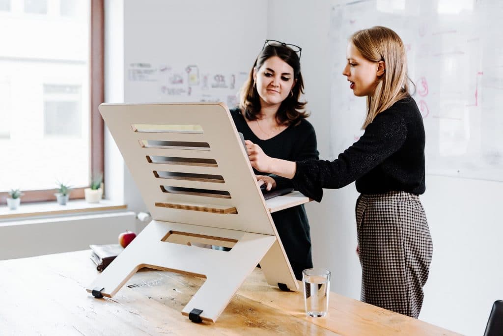 stand up desk converter with two women