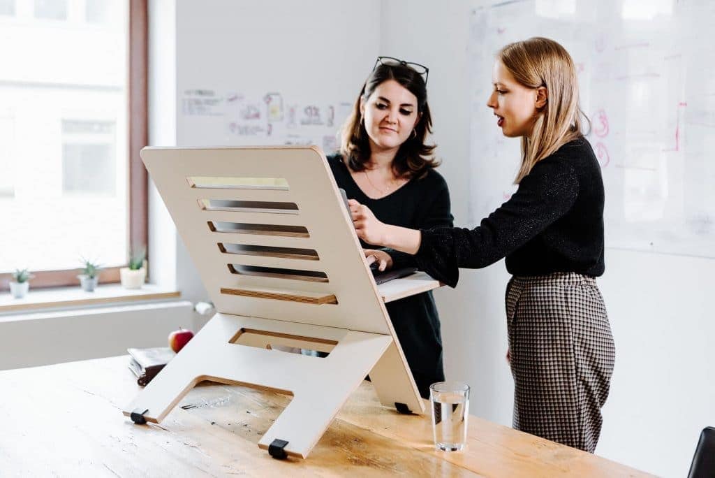 two women and standing desk