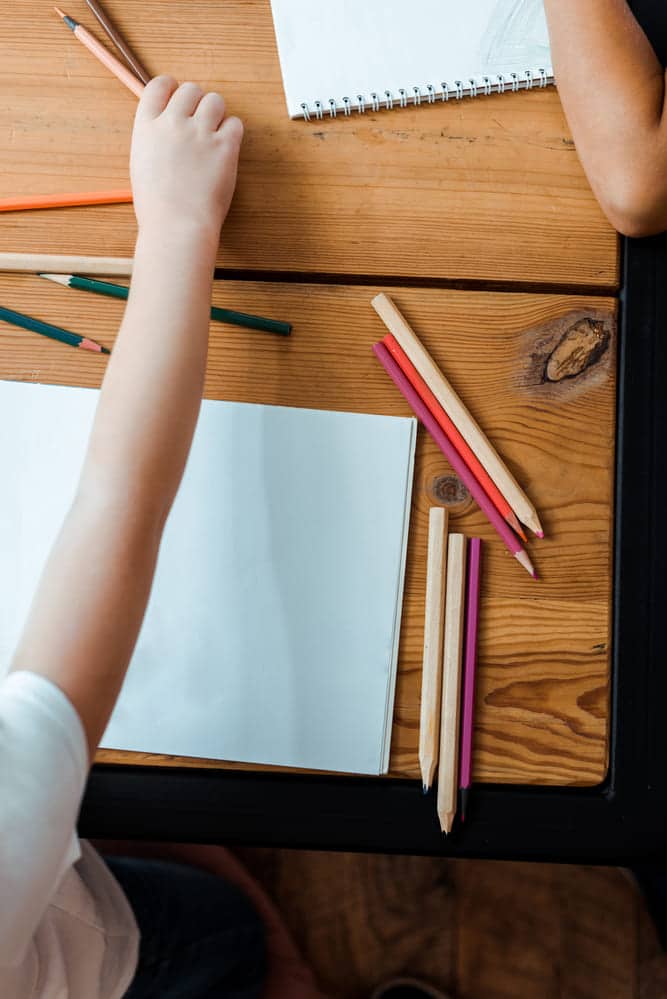 kid drawing at desk