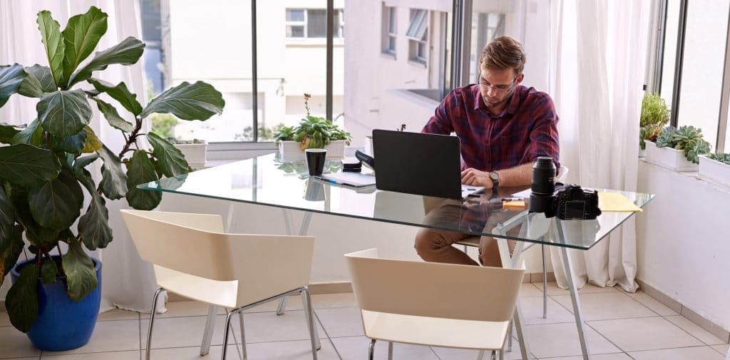 man sitting at glass desks