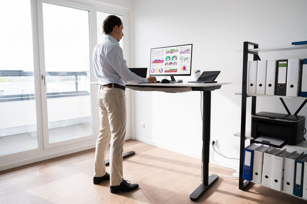 man at standing desk workplace