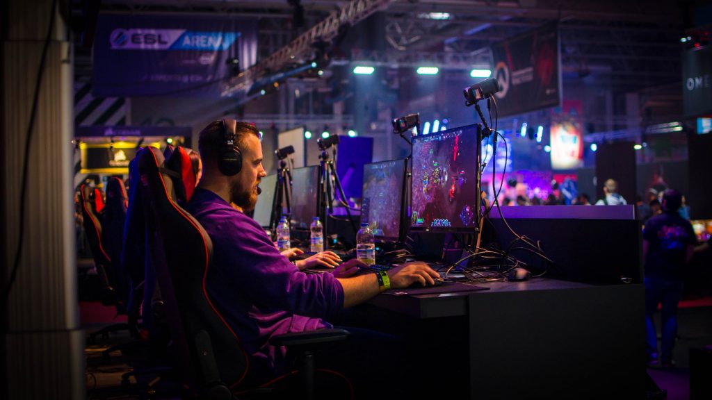 man sitting at computer gaming esports