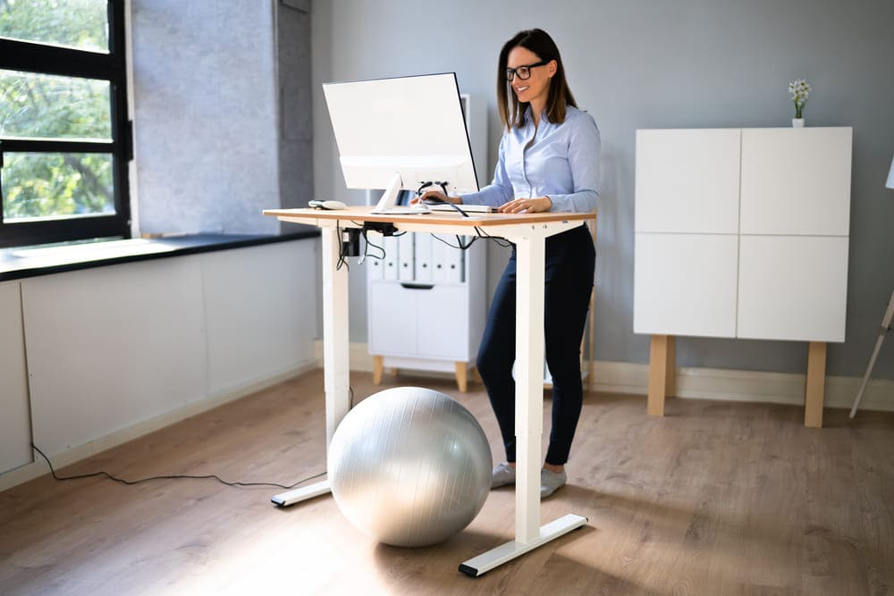 woman standing desk chair featured image