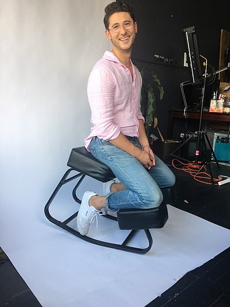 man sitting on kneeling chair