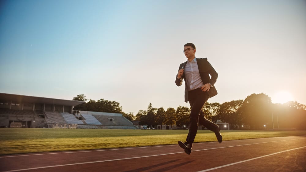 young male running in suit