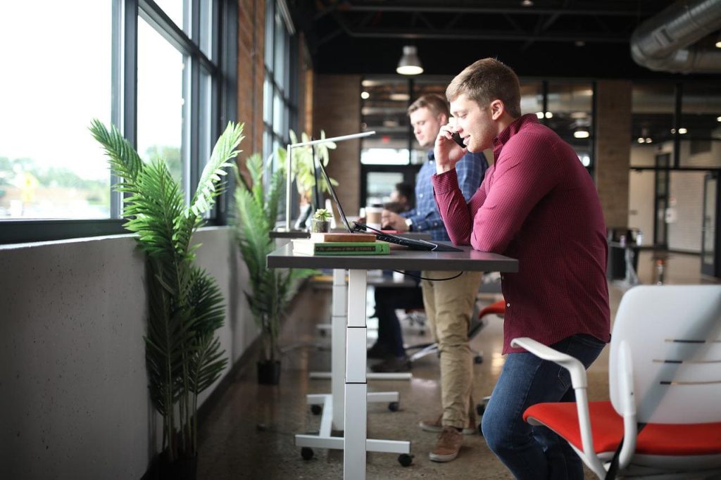 man using a standing desk